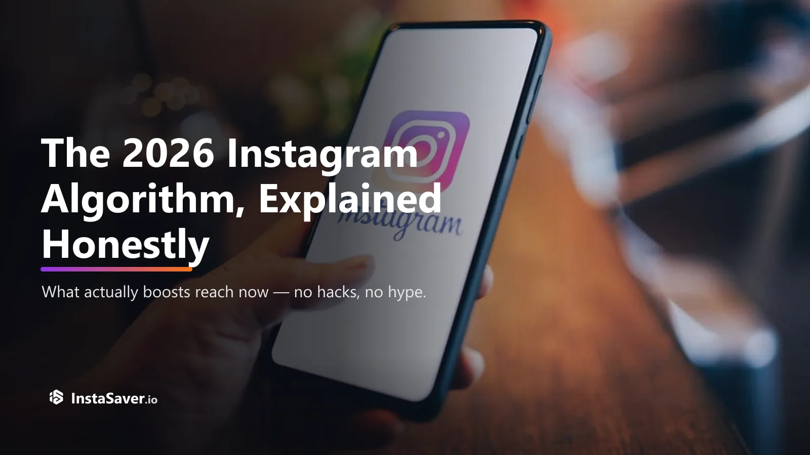 A hand holding a phone showing the Instagram app in a café